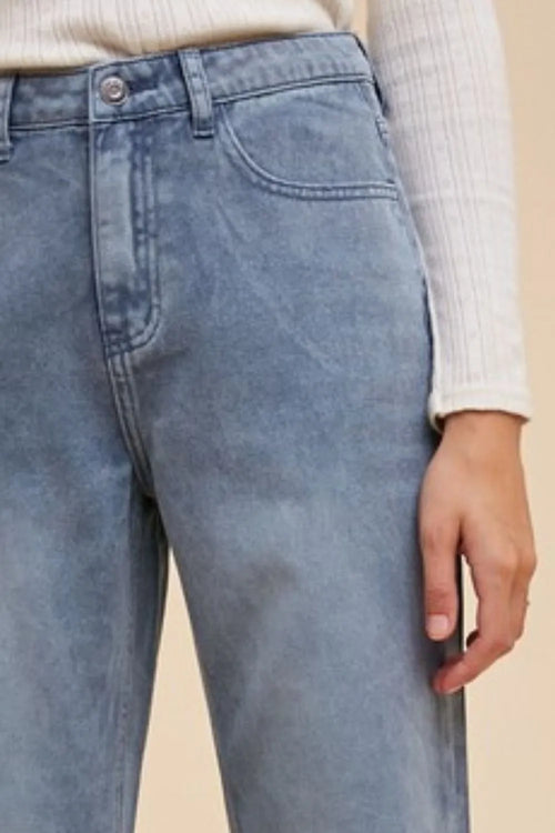 Annie Wear distressed raw hem jeans by Trendsi, showcasing a stylish fit with frayed edges and casual denim texture.