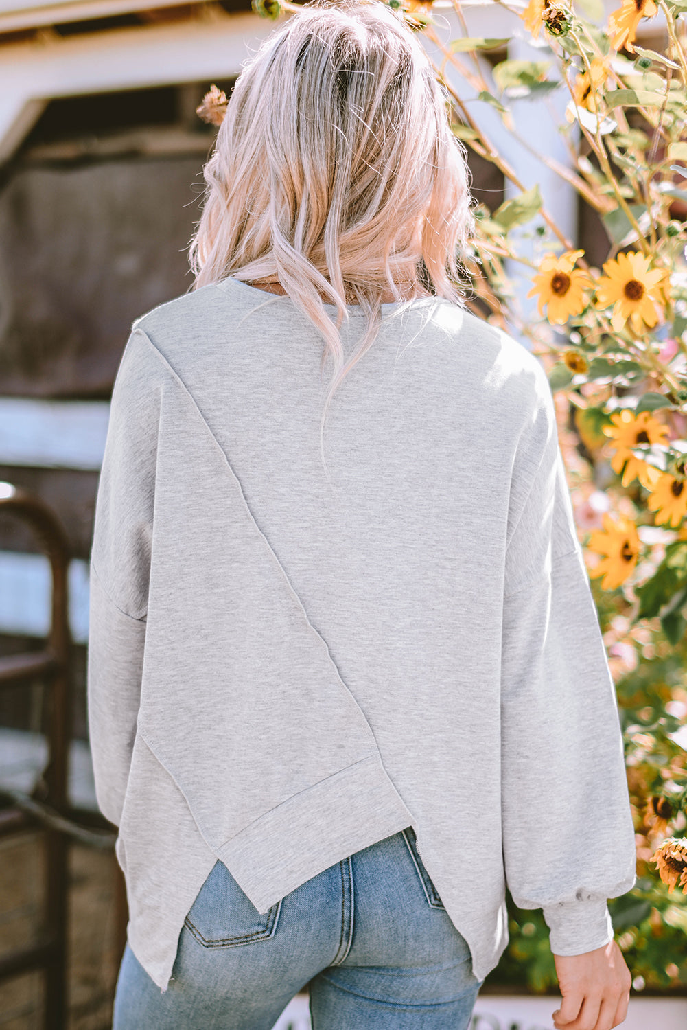 Colorblock stitching irregular hem long sleeve top by Dear-Lover with contrasting panels and unique hem design.