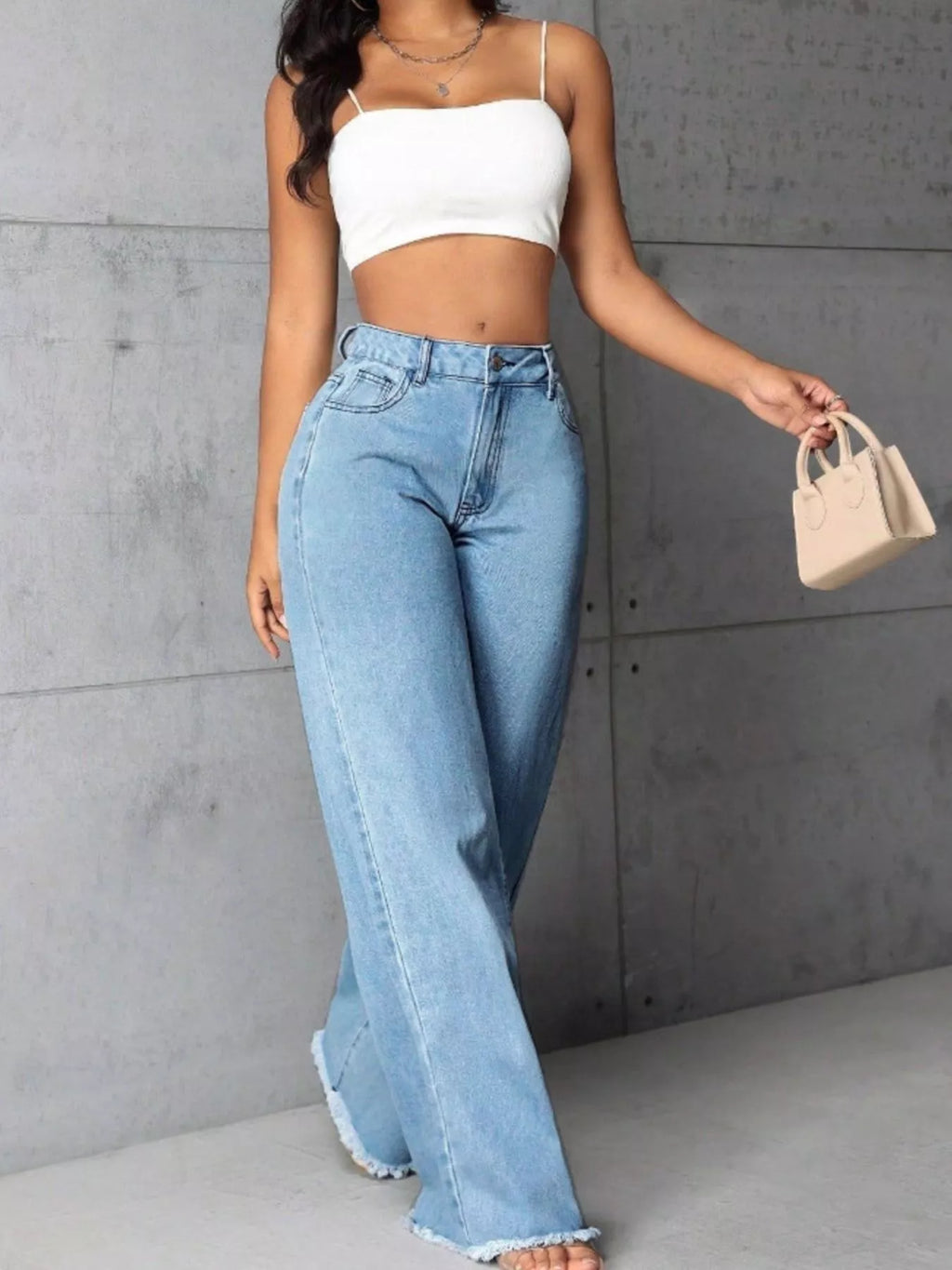 Plus size high-waisted wide leg raw hem jeans by Trendsi, showcasing the full length and relaxed fit of the denim.