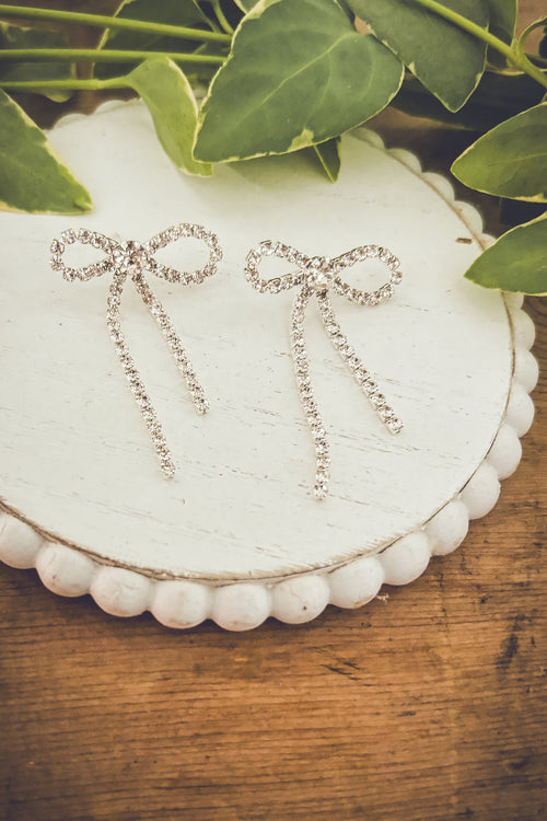 Crystal bow earrings from Rooted Home Goods with sparkling crystal accents and delicate bow design, perfect for elegant accessories.