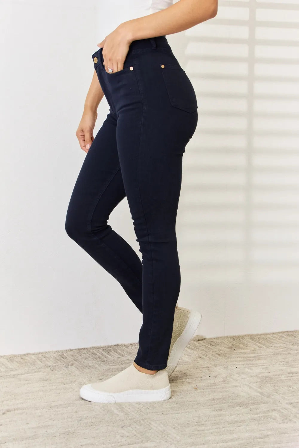 Judy Blue full-size garment dyed tummy control skinny jeans with a close-up of the denim fabric and fit.