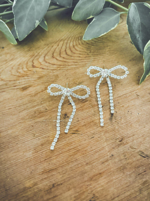 Adorable crystal bow earrings featuring sparkling crystals and delicate design, perfect for elegant accessories.