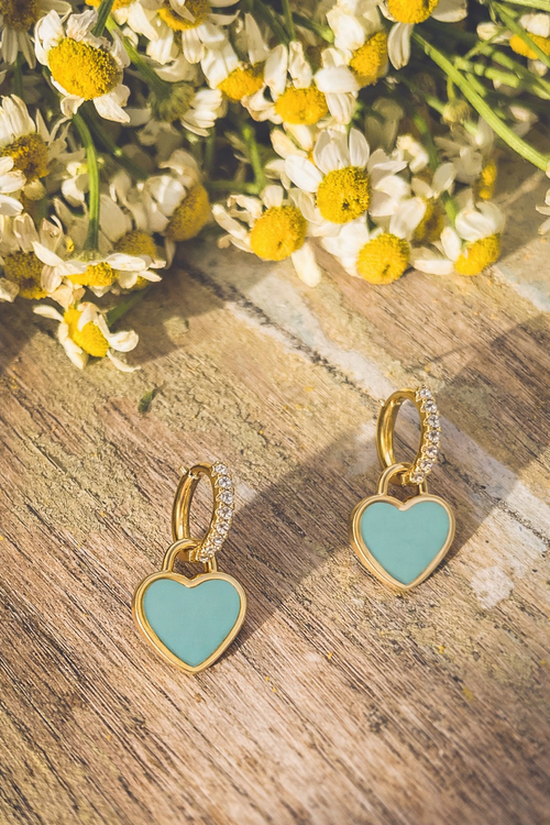 Gold and turquoise heart-shaped huggie earrings by Rooted Home Goods with detailed heart design and secure hoop closure.