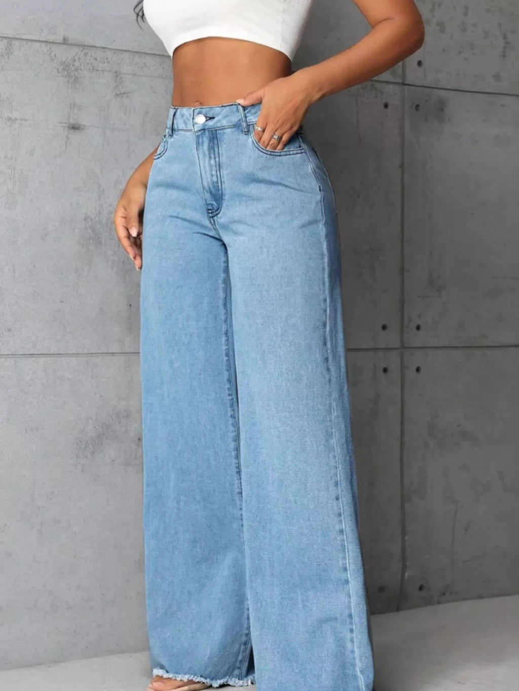 Plus size high-waisted wide-leg raw hem jeans by Trendsi, featuring a full size fit and stylish relaxed denim look.