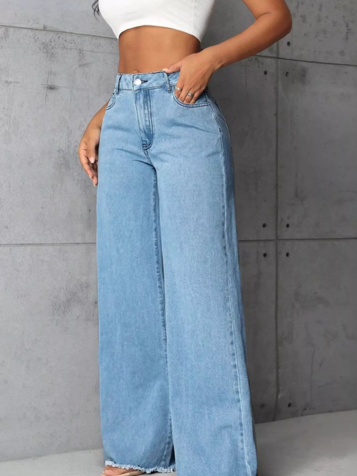 Plus size high-waisted wide-leg raw hem jeans by Trendsi, featuring a full size fit and stylish relaxed denim look.