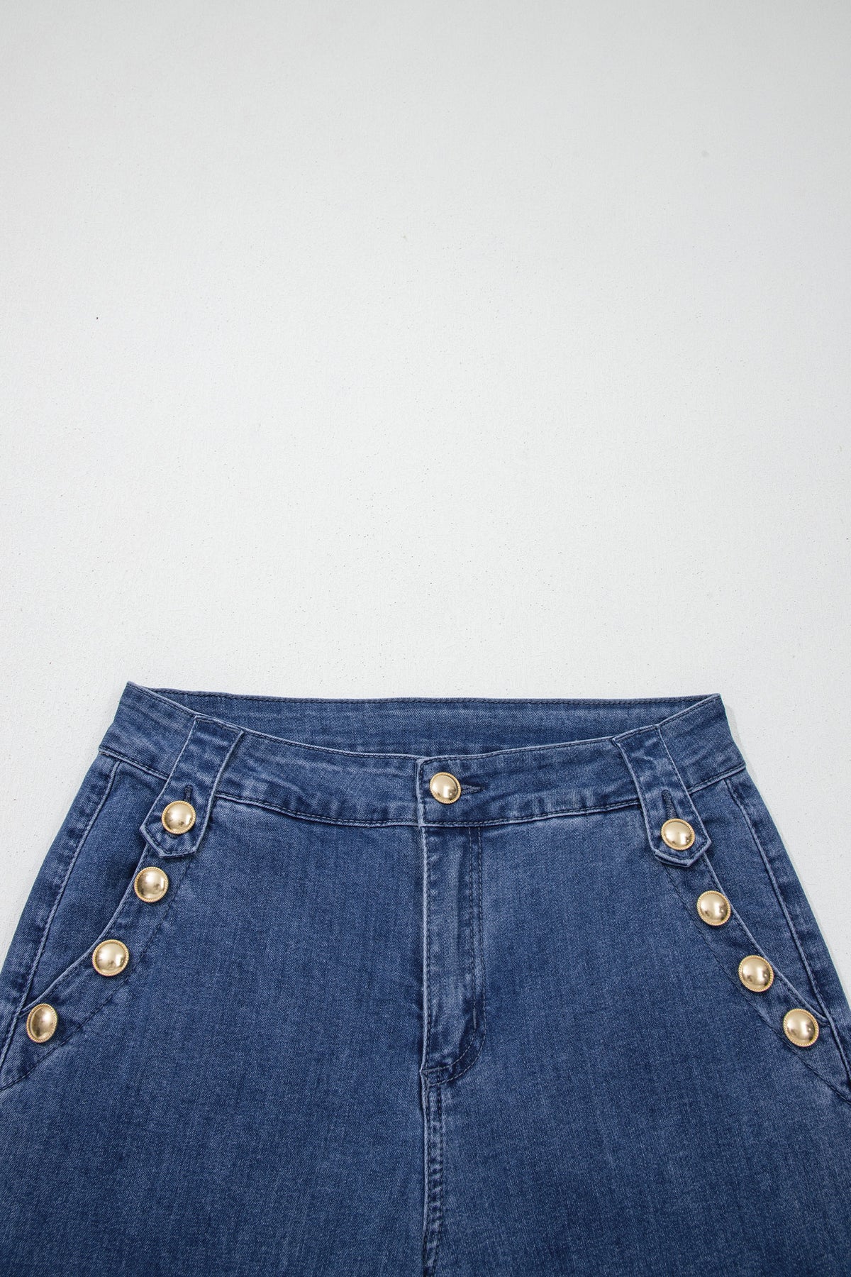 Dear-Lover Ashleigh blue flare jeans with golden button details and rolled edges, featuring a stylish flare leg design.