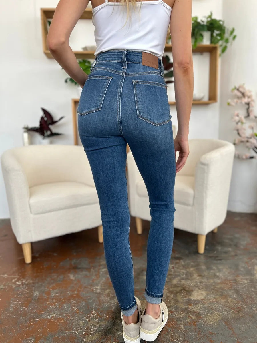 Judy Blue full-size cuffed hem skinny jeans in dark wash, featuring a classic five-pocket design and form-fitting silhouette.