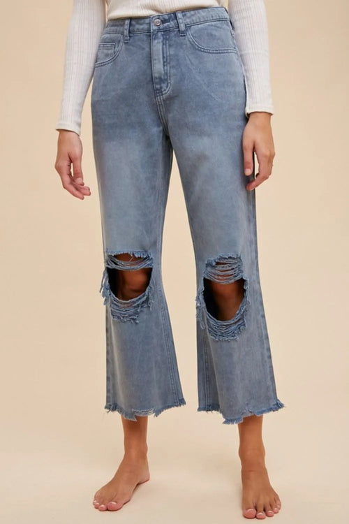 Distressed raw hem blue jeans by Annie Wear, trendy denim bottoms with frayed edges, casual and stylish for everyday wear.
