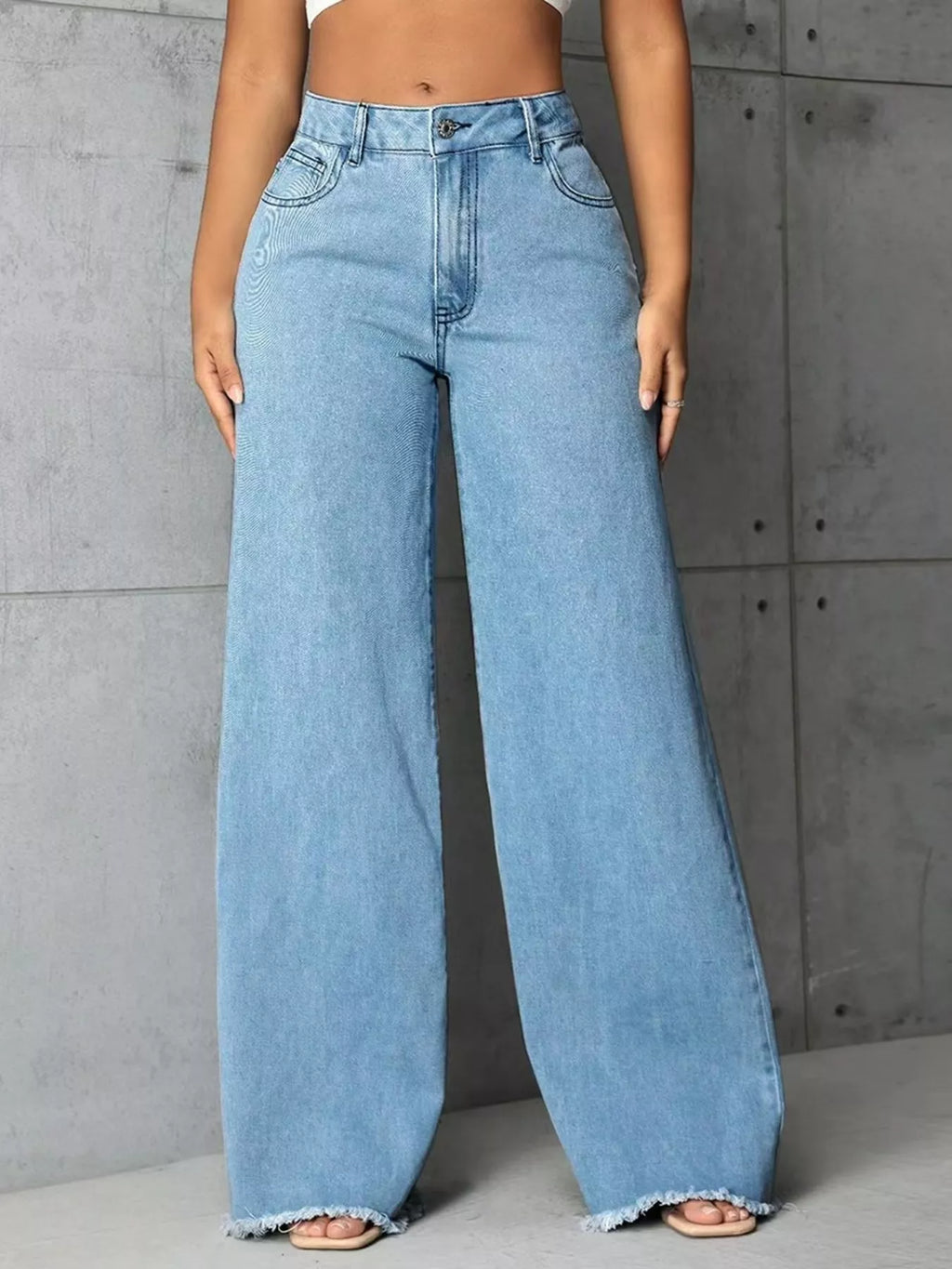 Plus size high-waisted wide leg raw hem jeans by Trendsi, featuring a full size fit and stylish relaxed design.