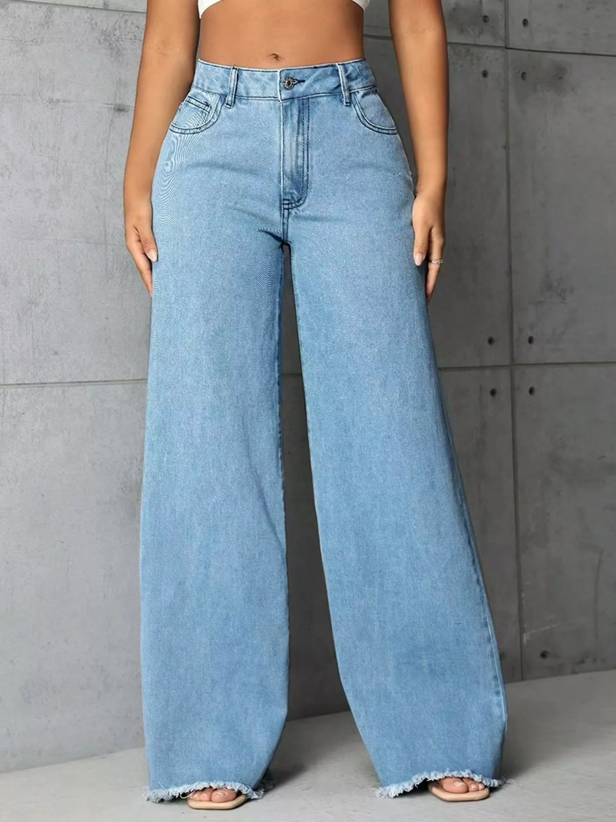Plus size high-waisted wide leg raw hem jeans by Trendsi, featuring a full size fit and stylish relaxed design.